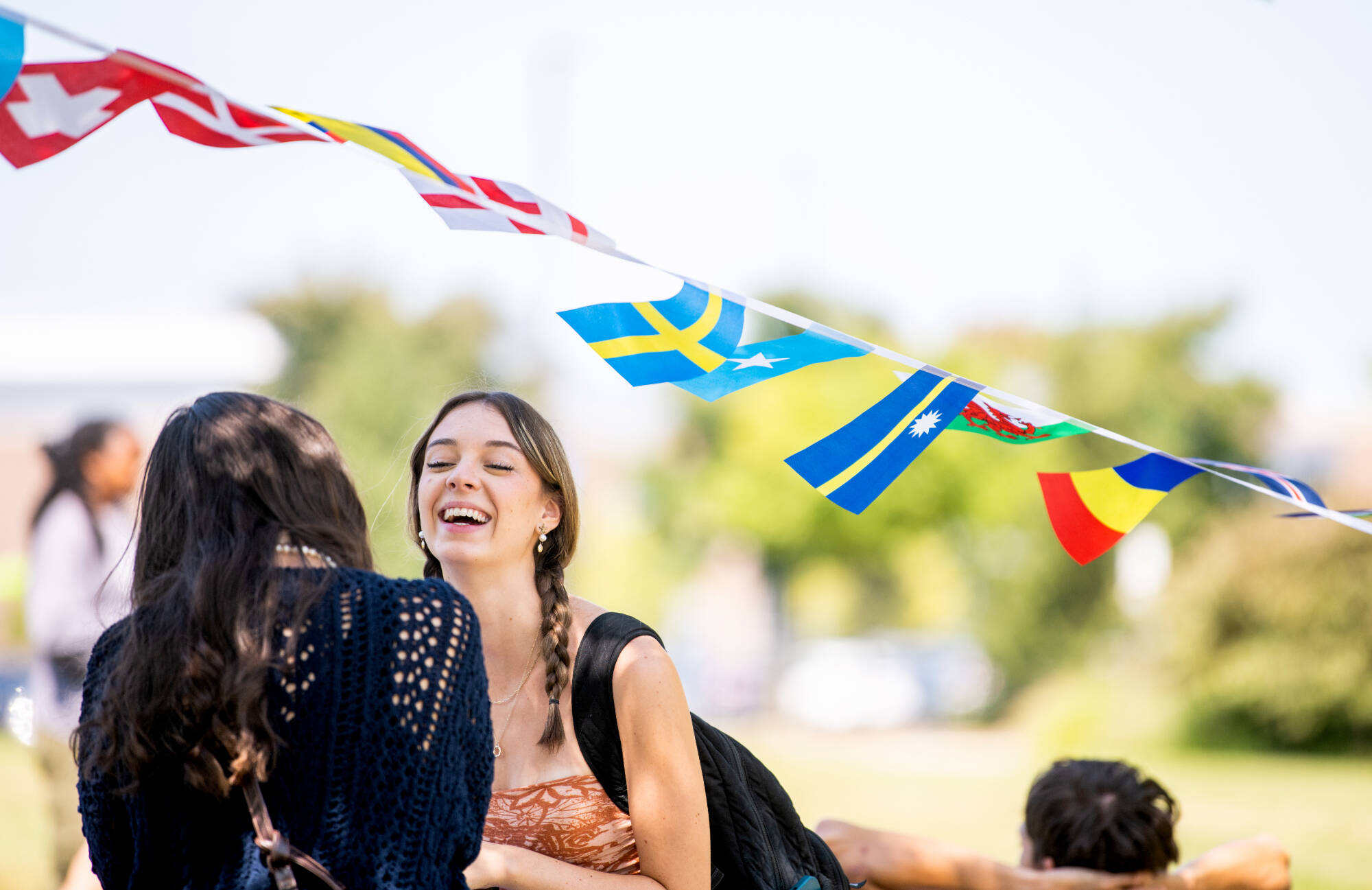 First-year students Leah Yancy and Cora Adamczak enjoy lawn games at the Global Laker Festival by the carillon tower.